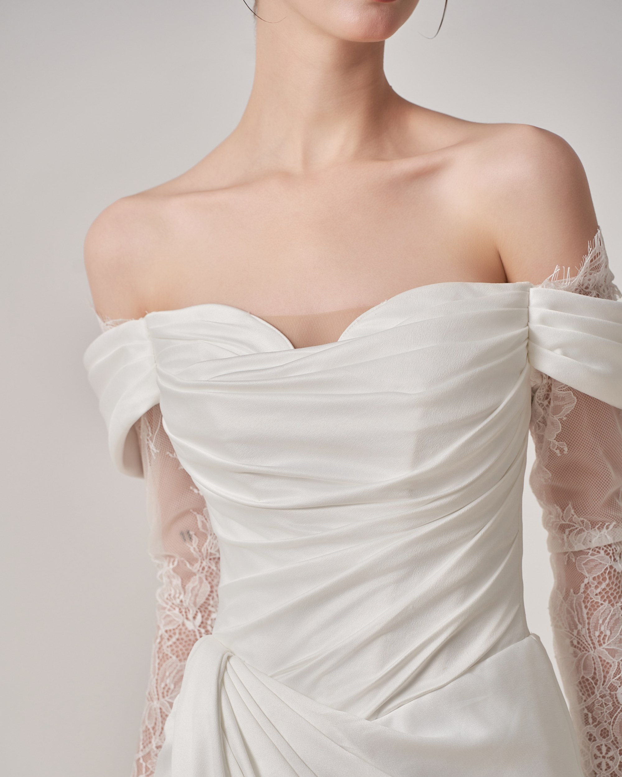 Hand-draped off-the-shoulder satin bodice with lace sleeves